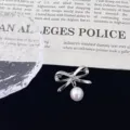 Silver bowknot brooch featuring a dangling pearl, elegant accessory for stylish women's clothing. - Bowknot Pearl Brooch (R1133) / Silver