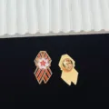 Vintage Soviet style metal lapel pin with black and orange ribbon design, durable enamel badge. - R1142