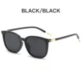 Schwarze runde Sonnenbrille für Damen, stilvoller UV-Schutz mit goldenen Metalldetails. - Schwarzer Rahmen Schwarzgraue Linse