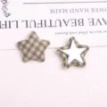 Detailed view of vintage plaid fabric five-pointed star button patch, DIY coat accessory. - Light Green