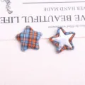 Detailed view of retro plaid star fabric buttons and DIY patches for coats and clothing decor. - Orange Blue