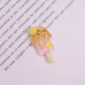 Detailed shot of resin melted fruit popsicle DIY cabochon accessory, glitter finish. - Pineapple