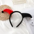 Close-up detail of the black and red plush clown horn headband, perfect for Halloween. - Bicolor Clown Horn Headband / Red + Black