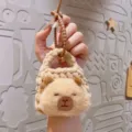 Cute handmade knitted plush capybara coin purse keychain with brown silicone strap for kids. - Squinting Capybara Coin Purse / Brown