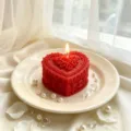 Handcrafted red heart scented soy candle with rose floral relief and romantic candle light decor. - 6x6x6cm / Red