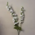 Vista dettagliata dei gambi di fiori artificiali bianchi, con petali delicati e foglie verdi. - Fiori Sen