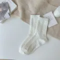 Thickened cable-knit woolen mid-tube socks in solid off-white, cozy winter wear. - One Size / White