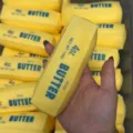 Detailed view of the yellow butter stick squishy toy showing soft slow rebound texture. - Butter Cheese Bar