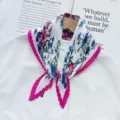 Pleated floral print scarf close-up, elegant pink border, chic neck accessory detail for women. - Rose Red Edge