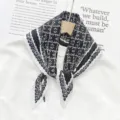 Detailed view of a stylish black and white pleated geometric print women fashion scarf. - Black