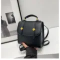Detailed view of stylish black leather mini backpack with gold hardware and top handle design. - 20x9x20cm / Black