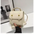 Off-white mini backpack detail showing delicate metal buckles, elegant PU leather texture. - 20x9x20cm / Off White