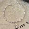 Brazalete de plata minimalista con perla y colgante de corazón para mujer elegante. - Plateado