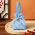 Blue fabric candy bag with handle ribbon and gold double happiness charm for wedding party gifts. - Light Blue + Round Xi