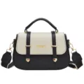 Black and white leather top handle saddle bag with double strap and gold hardware. - Black and White