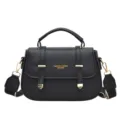 Retro black leather saddle bag with top handle, wide strap and chic front metal decor. - Black