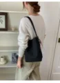 Vue détaillée du sac seau bandoulière tressé noir mettant en valeur l'artisanat fin. - Avec Pendentif / Noir