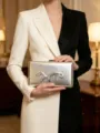 Silver metallic clutch bag detail featuring abstract liquid metal design and sparkly rhinestones. - Silver
