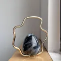 Details of the French style gradient eggshell evening bag with unique gold metal handle. - Black