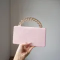 Close-up of pink crocodile texture mini handbag with chunky gold chain handle detail. - Pink