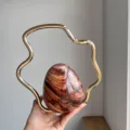 Exquisite detail of evening bag, irregular gold metal handle, brown gradient eggshell design. - Amber
