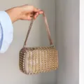 Detailed view of the luxury sparkling rhinestone beaded handbag and elegant shoulder strap. - Rose Gold