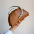 Brown pleated clutch with stunning curved crystal handle, elegant evening bag detail view. - Dark Brown