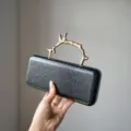 Black leather clutch bag with luxury gold branch handle, elegant evening party purse for women. - Black