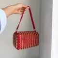 Detail view of a luxurious red crystal rhinestone shoulder bag, sparkling box handbag for women. - Red