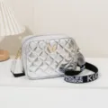 Silver quilted crossbody camera bag with stylish wide strap and butterfly charm for daily commute. - Silver