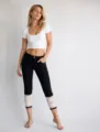 Women casual capri jeans featuring elegant white lace cuffs, paired with a fitted crop top. - S / Bottoms / Black