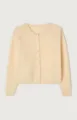 Detailed close-up view of the soft butter yellow knit cardigan with front button closure. - Apricot