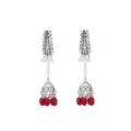 Detailed view of silver rhinestone long jhumka earrings with pearls and red beads. - Red