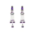 Close-up of exotic silver-tone long earrings with purple stones, carved fan and bell charms. - Dark Violet