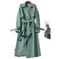Elegant women's mid-length trench coat with double-breasted buttons and belt in sage green. - S / Tops / Green