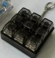 Mechanical keyboard switch fidget toy keychain 9 keys stress relief gadget detail shot. - Light-up / 1 Piece/Pack / Transparent Black