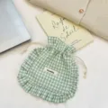Green gingham drawstring pouch detail with ruffled edge, cute fabric storage bag close-up. - Light Green Plaid
