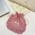 Close-up view of the red white gingham drawstring pouch with cute ruffles and small fabric label. - Bean Paste Red Plaid