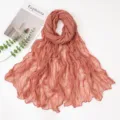 Detailed view of the elegant crinkled solid color long scarf, lightweight sheer shawl. - 180x90cm / Deep Pink