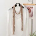 Detaillierter feiner Leinenschal drapiert an weißem Oberteil, elegantes modisches Accessoire. - 180x20cm / Kleiner Leopard Beige