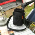 Black outdoor sports crossbody phone bag with drawstring closure and front mesh pocket. - Black