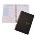 A5 spiral weekly planner notebook with black cover and non-dated inner pages for daily use. - Black
