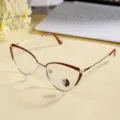 Detailed shot of stylish metal cat-eye glasses frame featuring photochromic anti-blue light lenses. - Wine Red Gold Frame