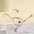 Detail shot of retro cat-eye anti-blue light glasses frame with gold and red metal design. - Photochromic Anti-Blue Light Style / Top Red Bottom Blue