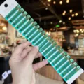 Close-up detail of clear green acrylic duckbill hair clips with gold lettering on card. - 20 Pieces/Pack / Lake Green