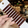 Detailed shot of brown acrylic hair clip, 4.7cm duckbill design, elegant side fringe accessory. - 10 Pieces/Pack / Coffee