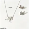 Detailed shot of silver butterfly necklace and matching earrings featuring elegant honeycomb wing design. - Necklace and Earrings Set / Silver