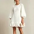 Elegant white mini dress featuring flower buttons, loose fit, and chic lantern sleeves. - S / White
