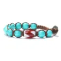 Handmade turquoise red dzi bead braided bracelet detailed view showcasing ethnic cord craftsmanship. - Blue Turquoise