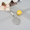 Metal tennis racket keychain with mini tennis ball charm, stylish backpack pendant. - Alloy Tennis Racket Pendant (K6726) / Yellow
